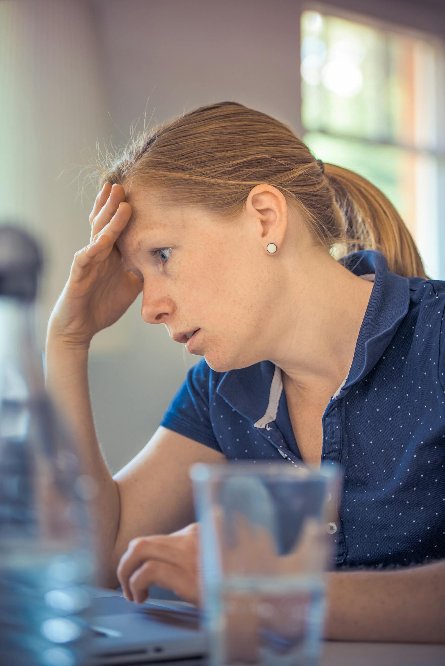 Businesswoman showing stress and concentration while working at her desk.